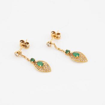 A pair of 18K gold earrings with faceted emeralds and round brilliant-cut diamonds.