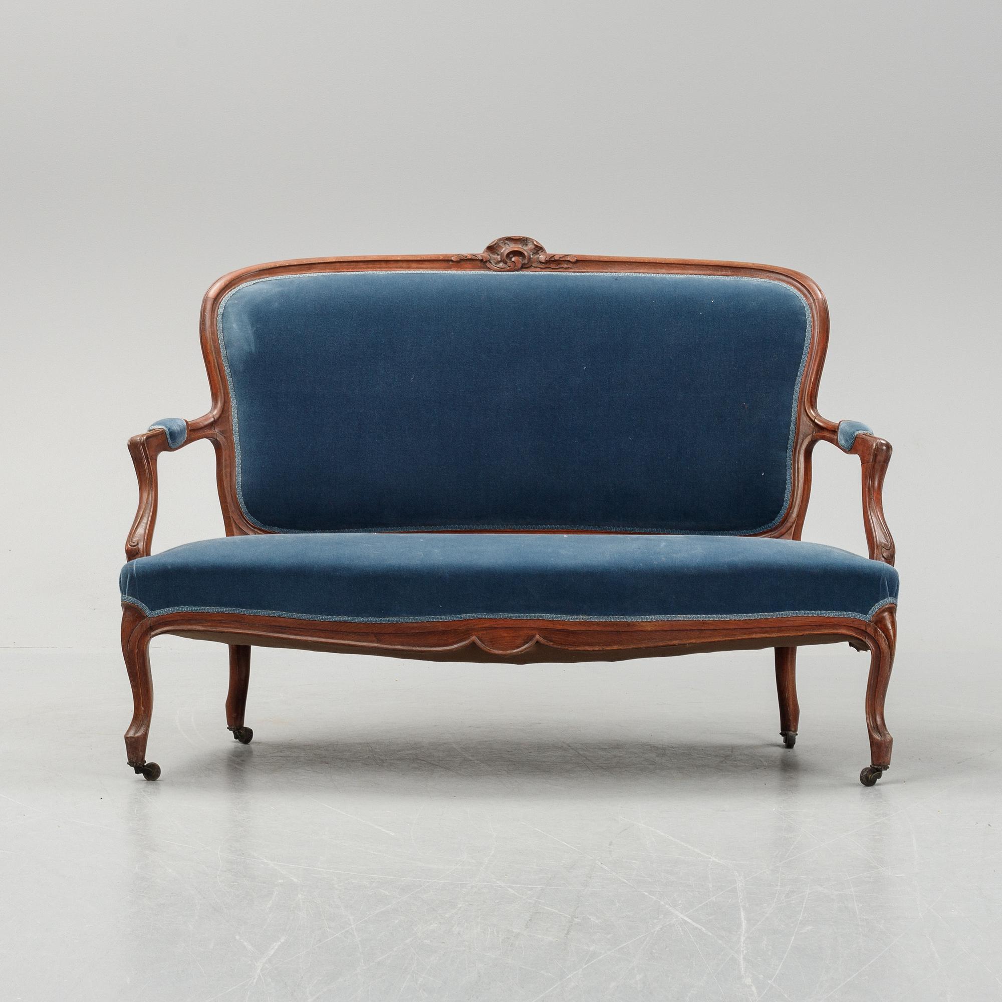 A sofa and a set of four chairs, Rococo revival, late 19th century.