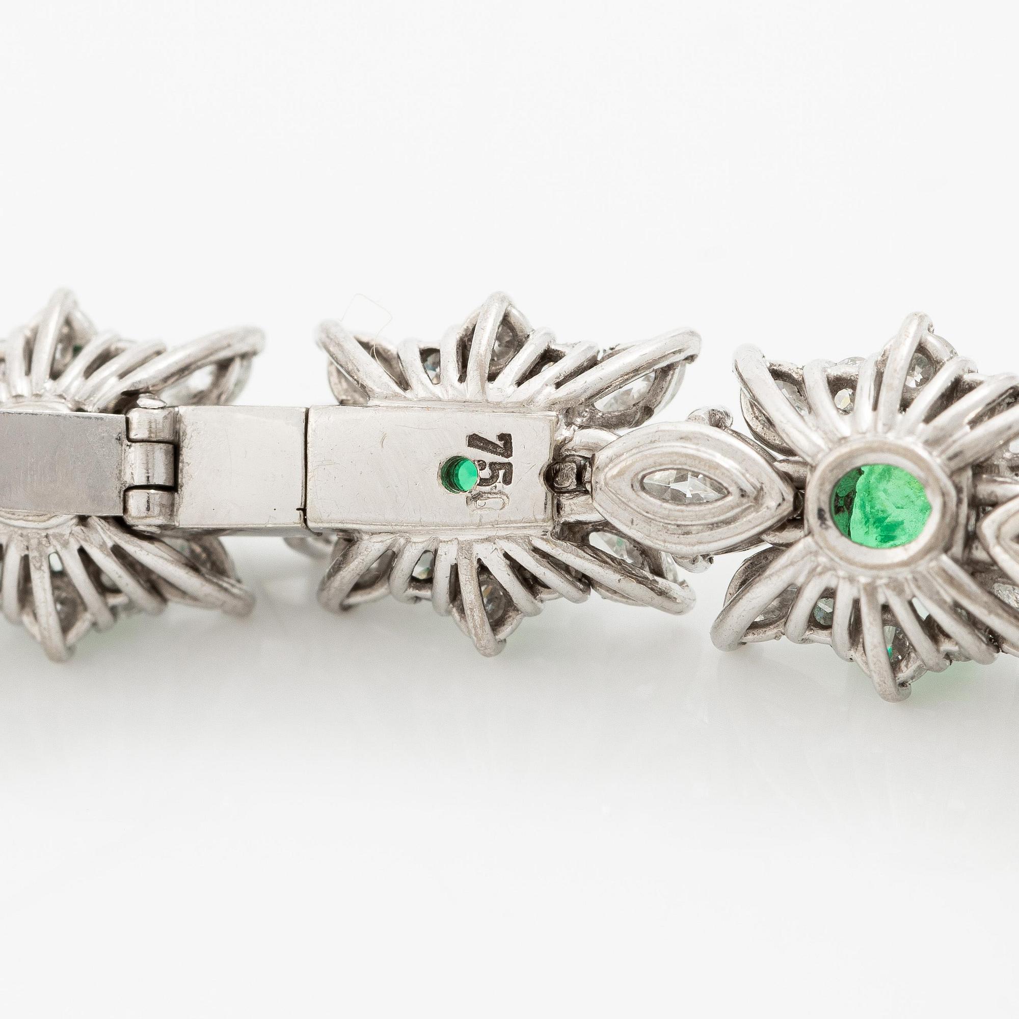 A bracelet in 18K white gold with step-cut emeralds and round and navette-shaped brilliant-cut diamonds.