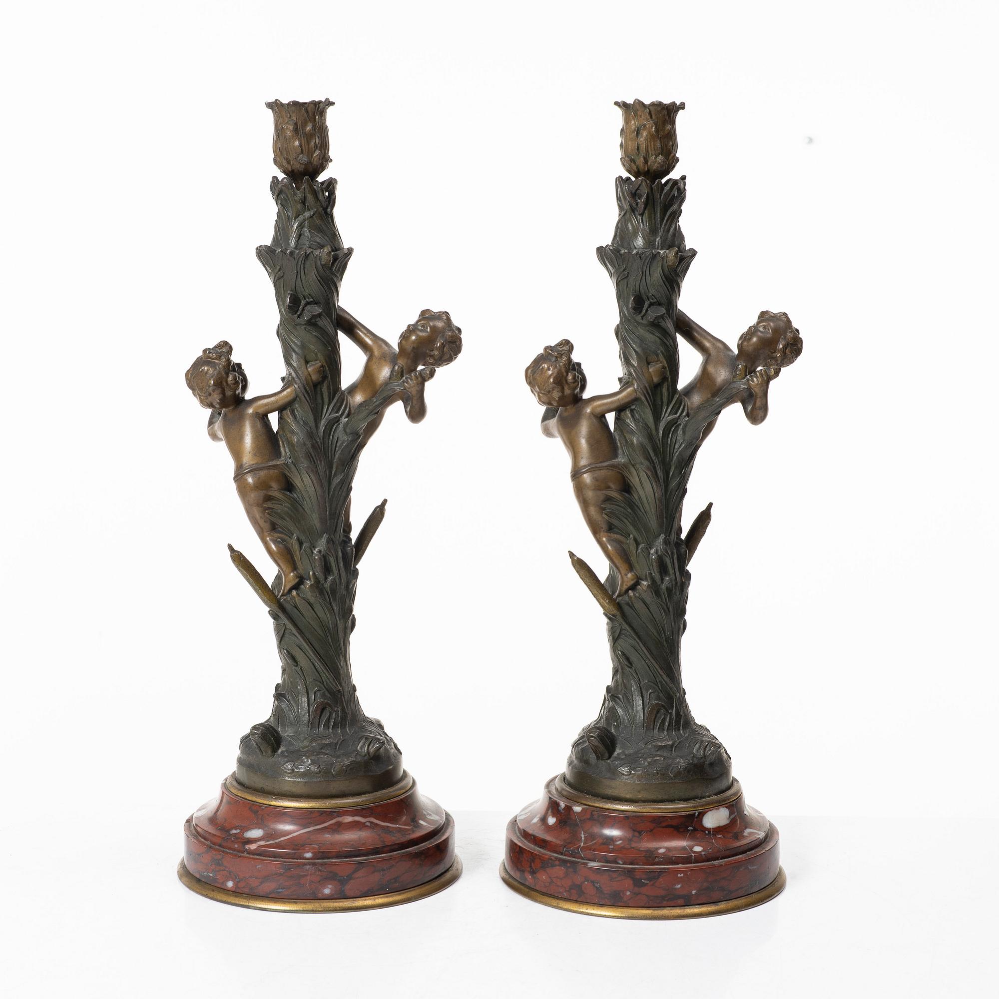 a pair of bronze and marble candle sticks, after a model by Houdon, late 19th century.