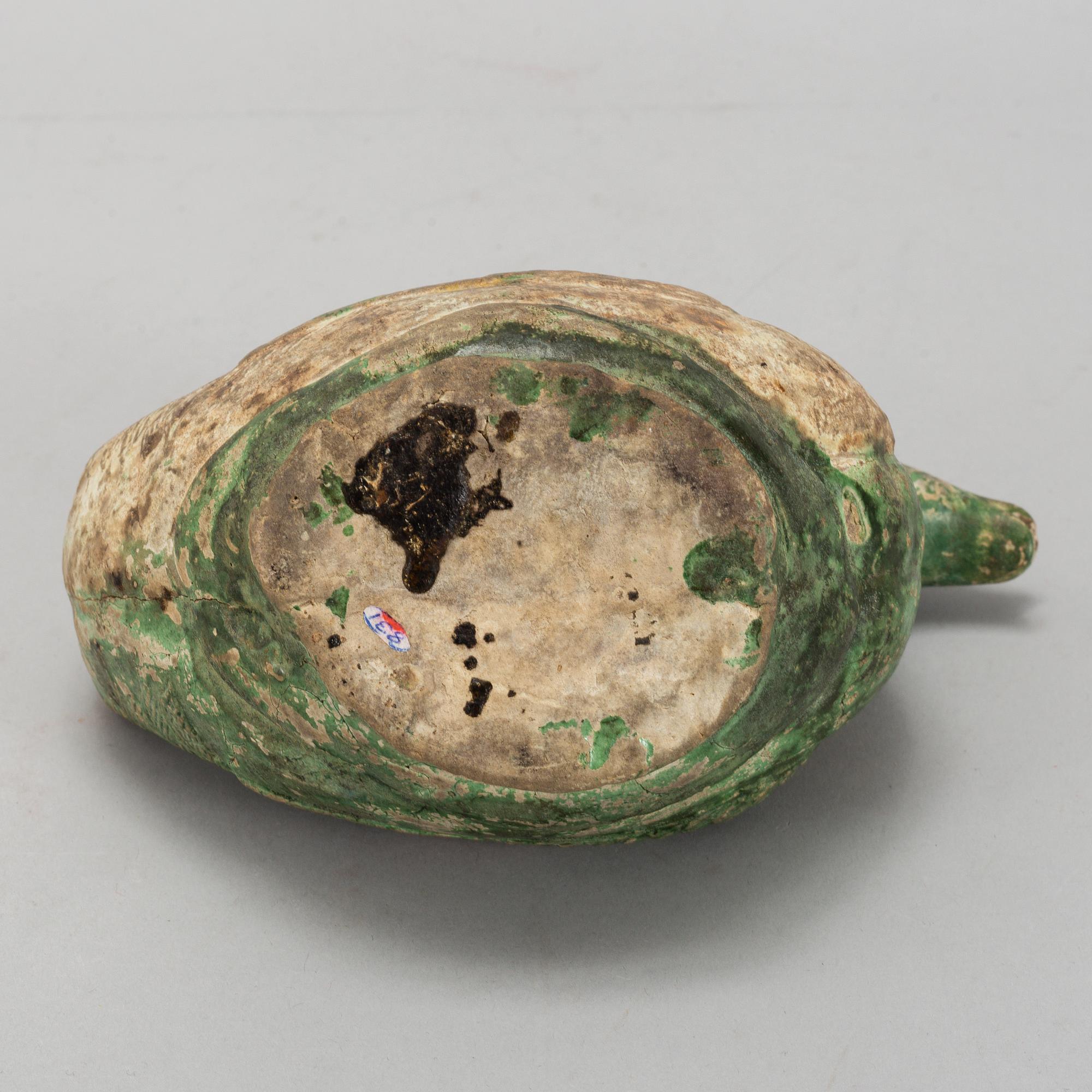 A green and yellow glazed bisquit duckshaped ewer, Ming dynasty (1368-1644).