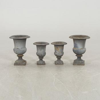 Two pairs of cast iron garden urns.