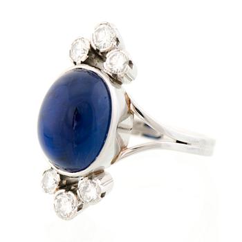 A RING, cabochon cut sapphire, brilliant cut diamonds, platinum. A. Tillander.