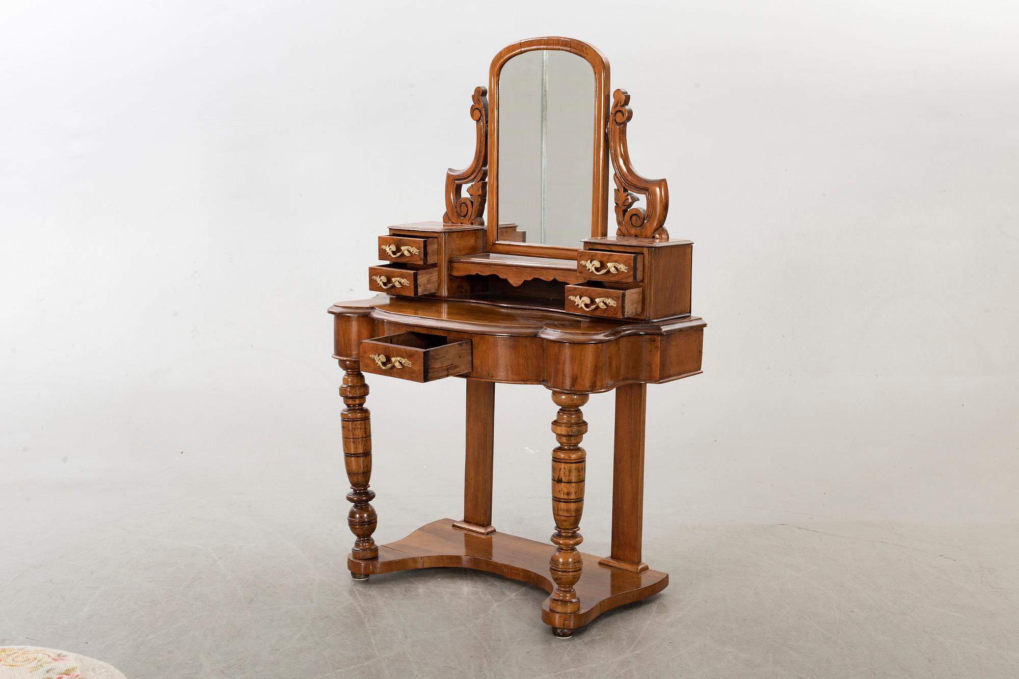A second half of the 19th century table with mirror and a stool.