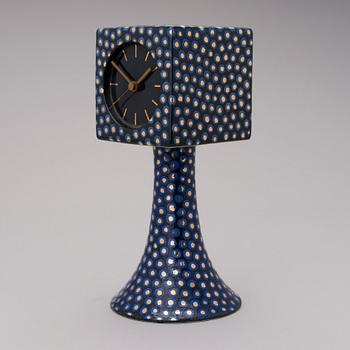 A stoneware clock signed Kaipiainen.