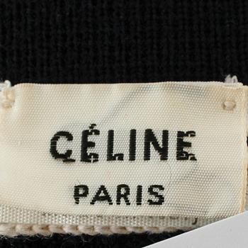 CÉLINE, a navy blue cardigan.
