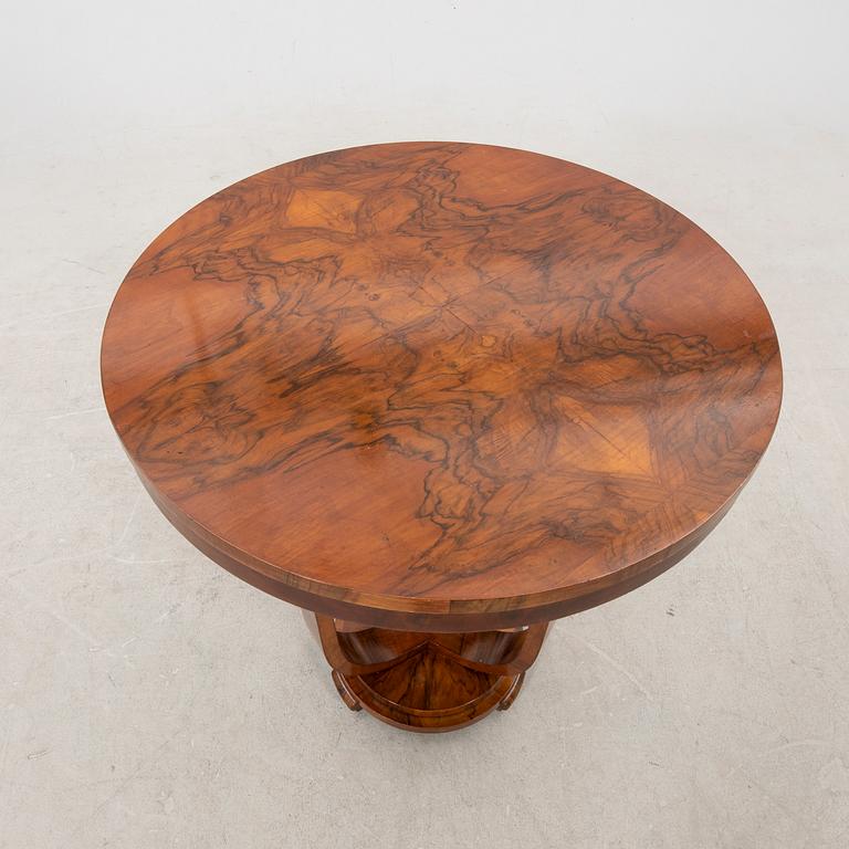 A stained walnut table from the first half of the 20th century.