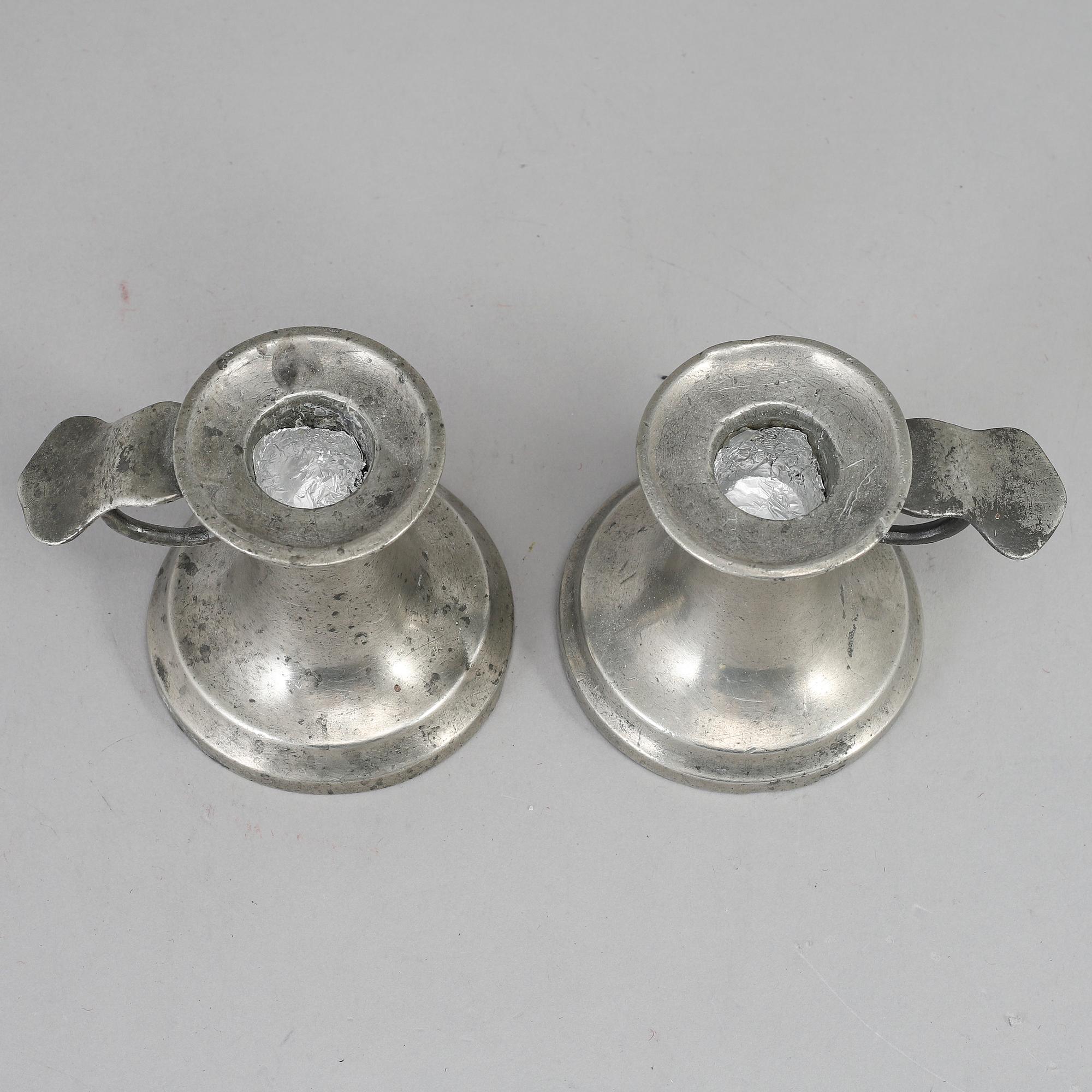 A pair of 19th century pewter candlesticks.