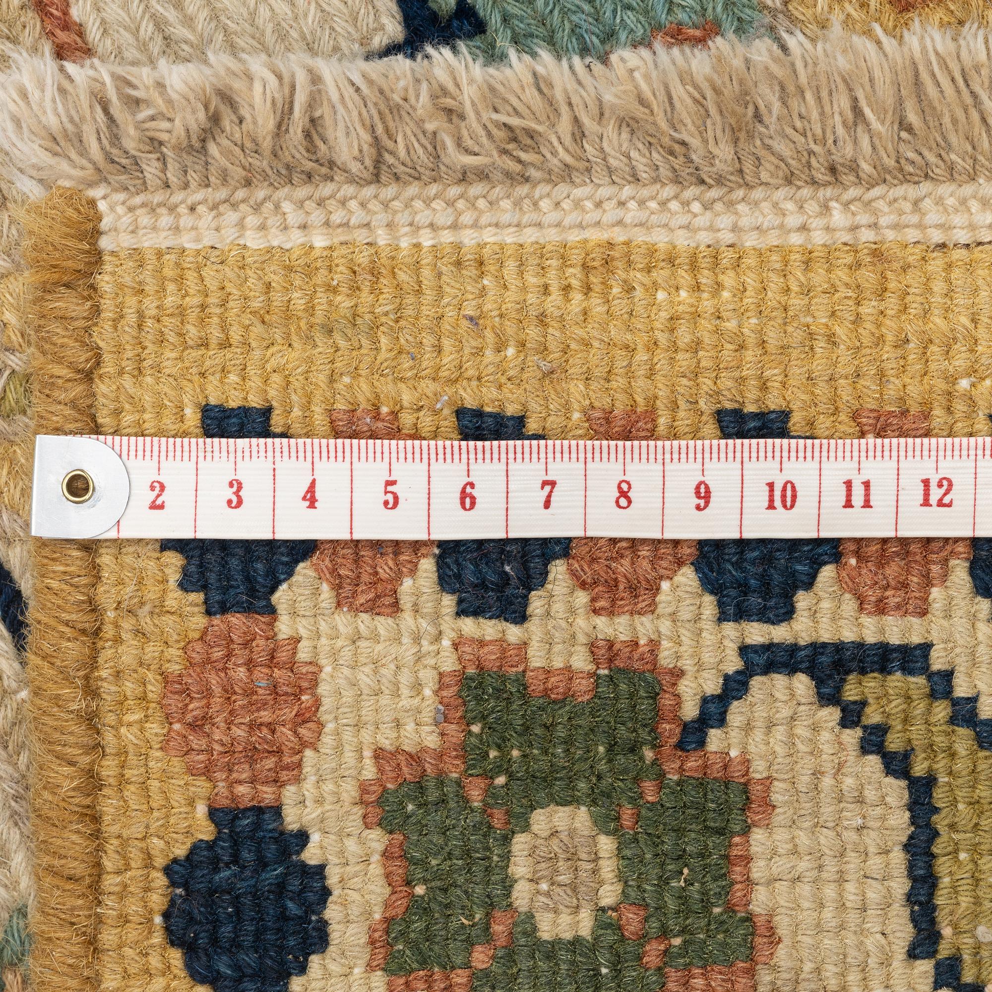 An Indian flat weave carpet of 'Shah Abbas' design, c. 402 x 289 cm.