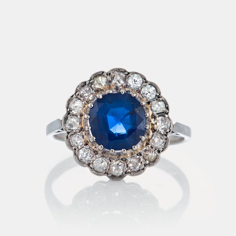 A platinum ring set with a faceted sapphire ca 1.90 cts and old-cut diamonds with a total weight of ca 0.50 cts.