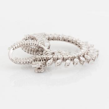 A platinum brooch set with navette-, tapered baguette- and brilliant-cut diamonds.