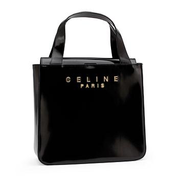 CÉLINE, a black patent leather purse.