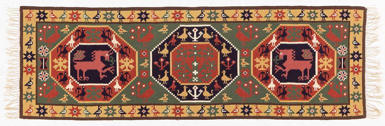 A bench cushion "Bäckahästen", flat weave, c 188 x 62 cm, Scania, around the year 1900.