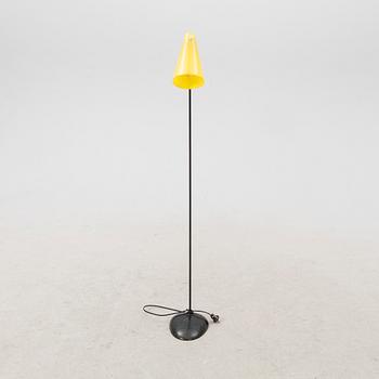 A 1050s metal and plastic floor lamp.