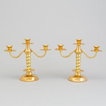 a pair of brass candelabras by Gottfrid Carlsson Eskilstuna.