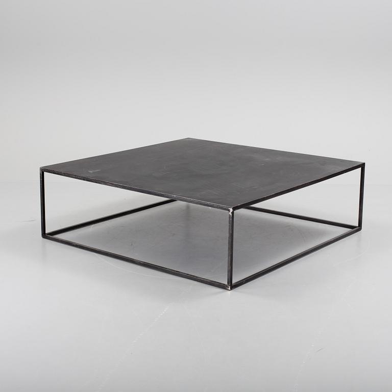 A modern square metal sofa table.