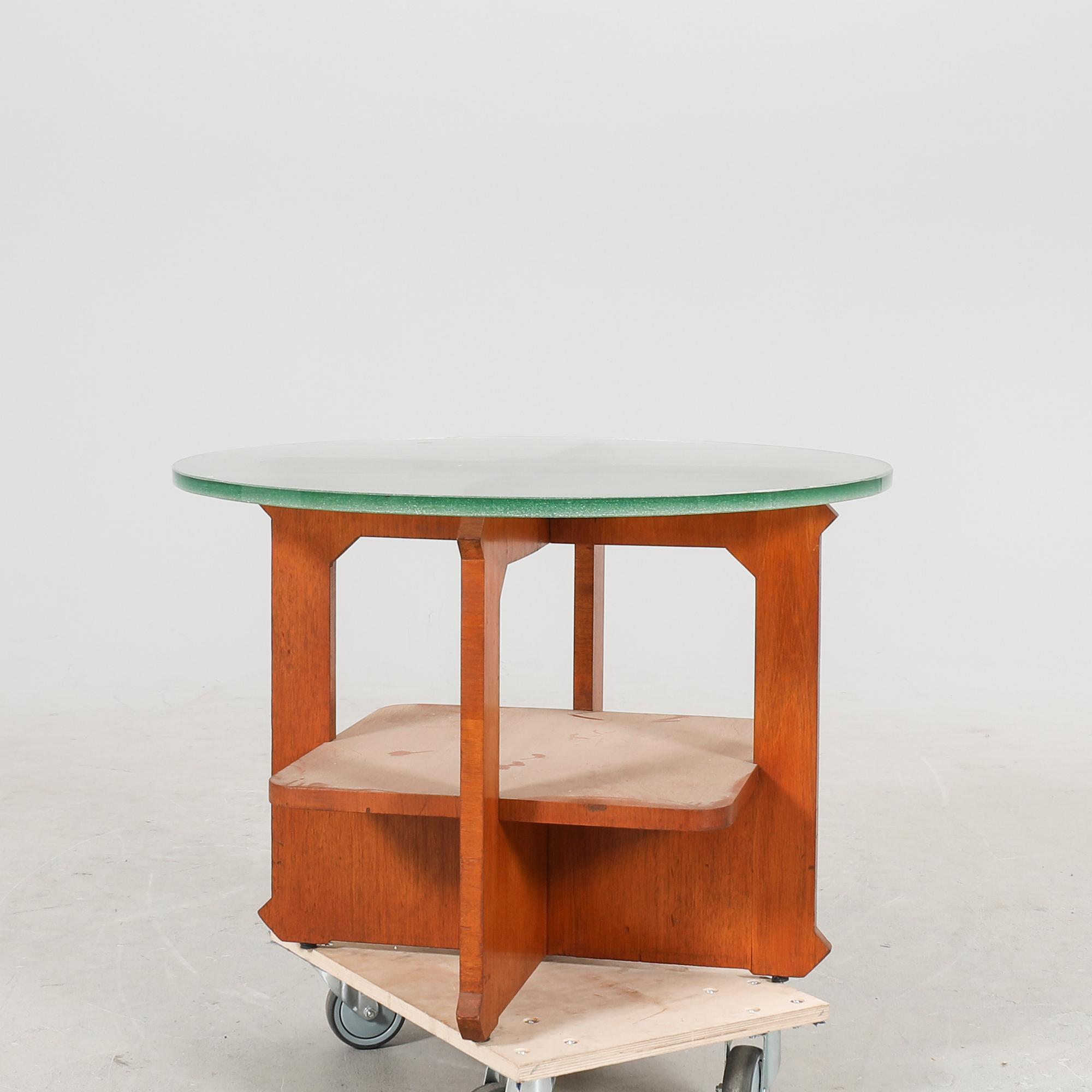 A 1940s wood and glass coffee table.