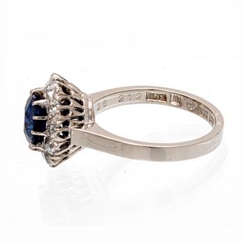 An 18K white gold ring with an oval old cut sapphire and round brilliant and old cut diamonds.