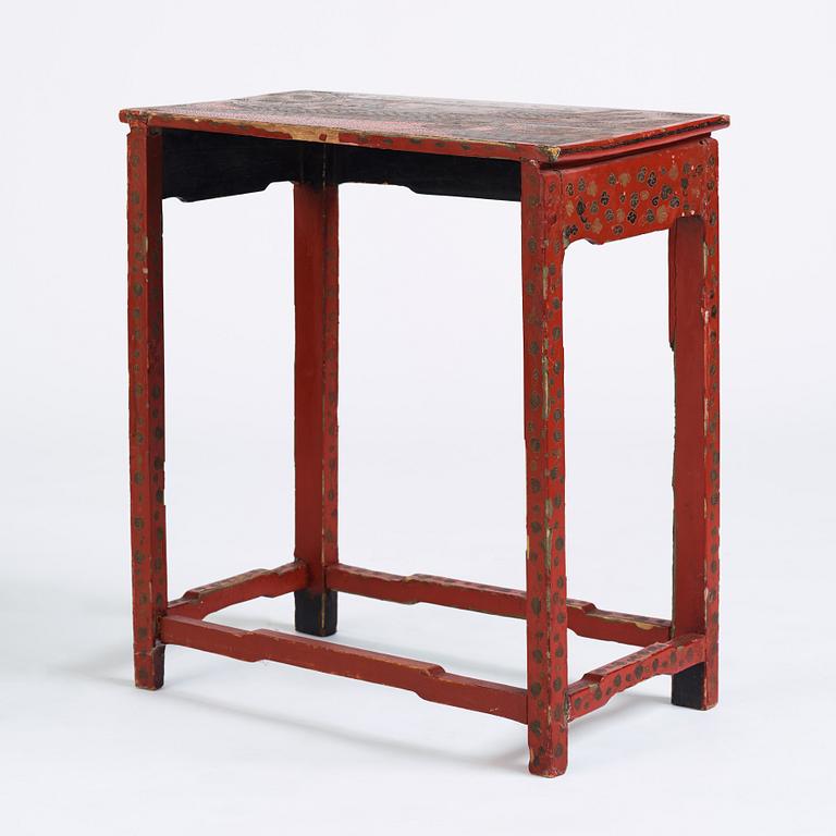 A red lacquer table, around 1900.