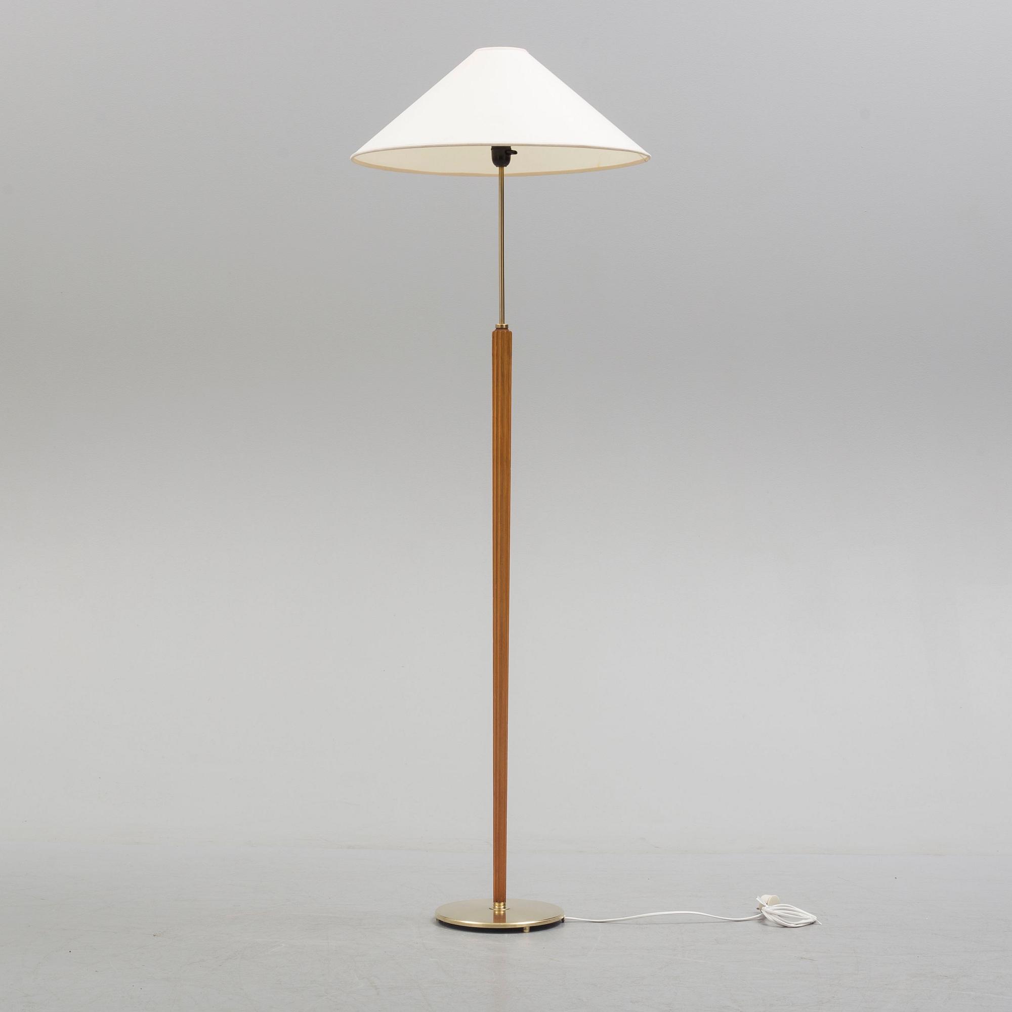 A Bergboms brass and beech standard light, 1940's.