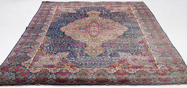 A semi-antique Kirman carpet, south Persia, c. 440 x 279 cm.