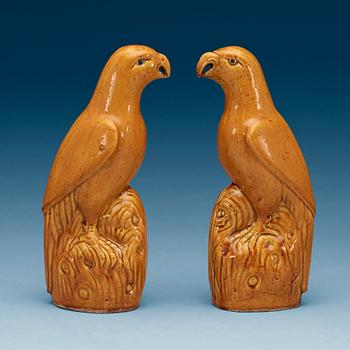 A pair of brown and yellow glazed figures of parrots, Qing dynasty, presumably 18th Century.