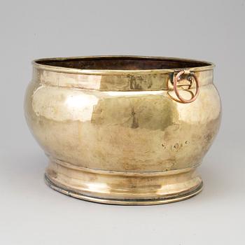 A 18th century brass champagne cooler.