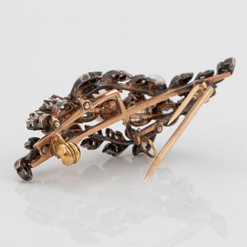 A silver and 14K gold brooch set with old- and rose-cut diamonds and pearls.