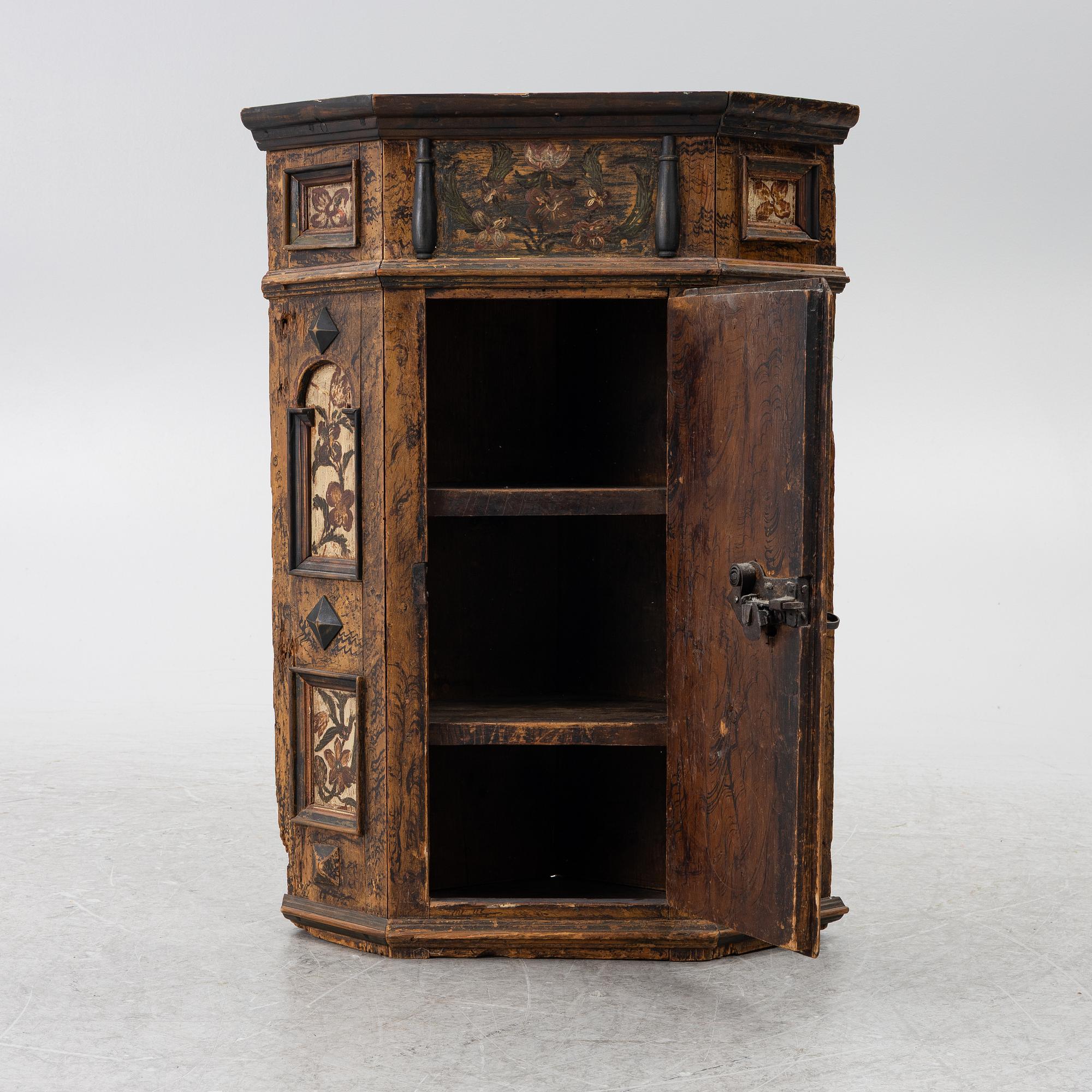 A corner cabinet, 18th Century.