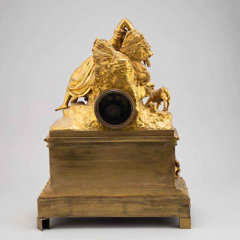 A mid 19th Century brass and gilt brass mantel clock.