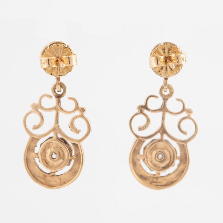 A pair of earrings in 14K gold set with round brilliant-cut diamonds.