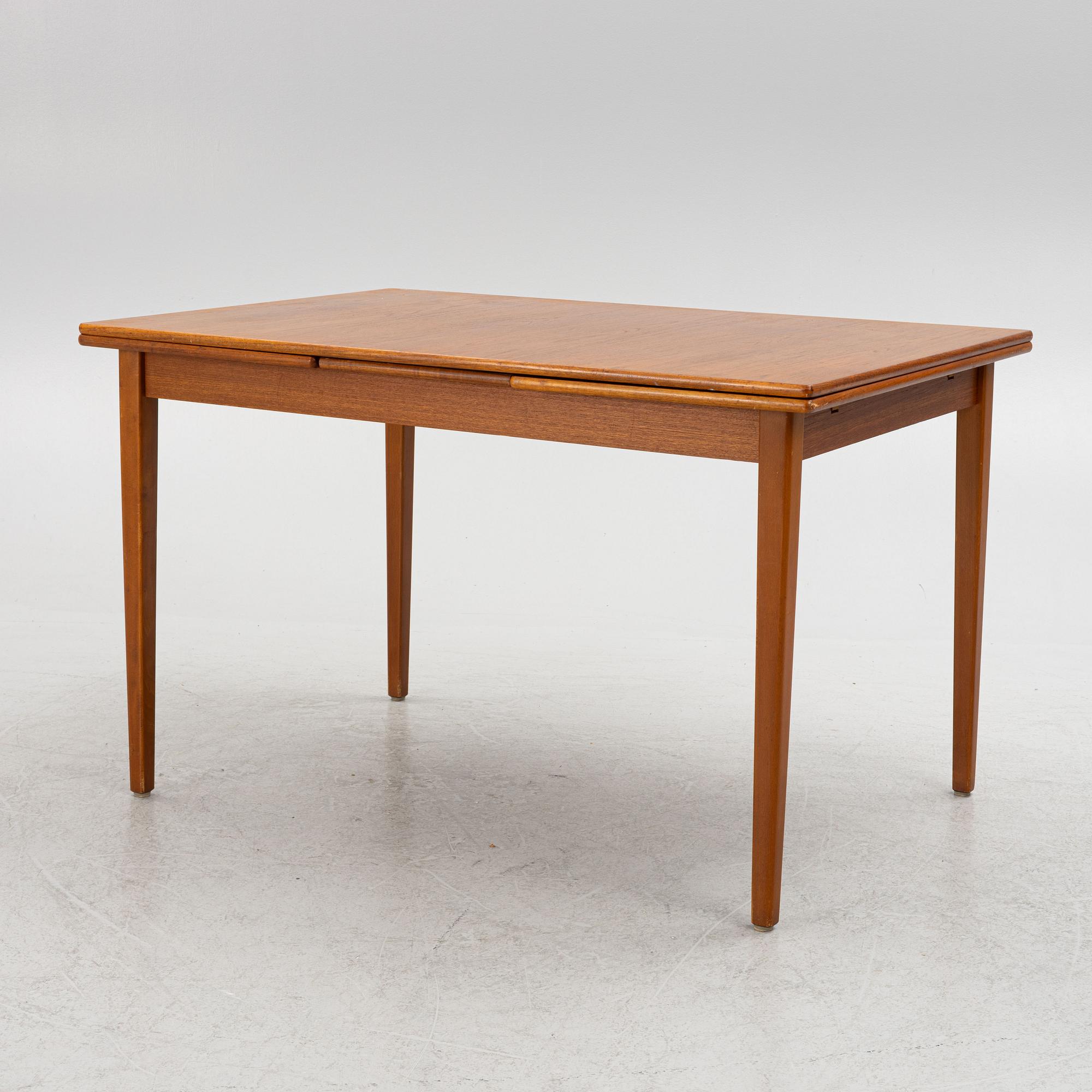A dining table with four chairs, mid 20th century.