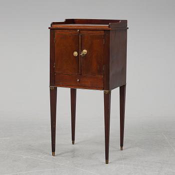 A first half of the 19th century mahogany veneered bedside table.