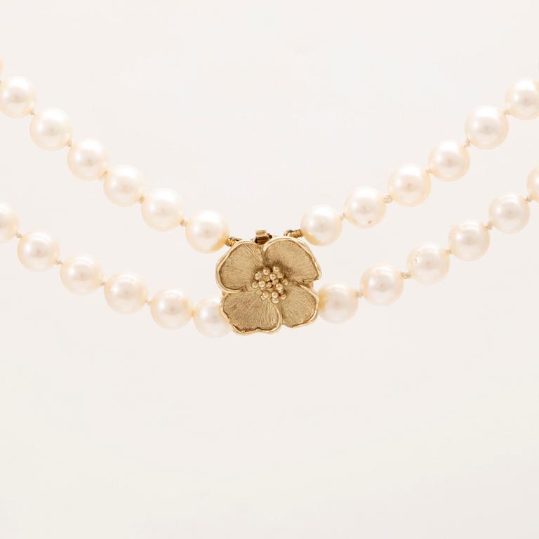 A two row cultured pearl necklace with 14K gold clasp.