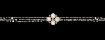 1018. NECKLACE, three rows with small pearls and clasp with small diamonds and cultured pearls.