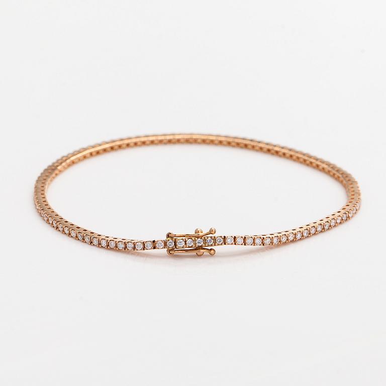 An 18K rose gold tennis bracelet with brilliant cut diamonds.