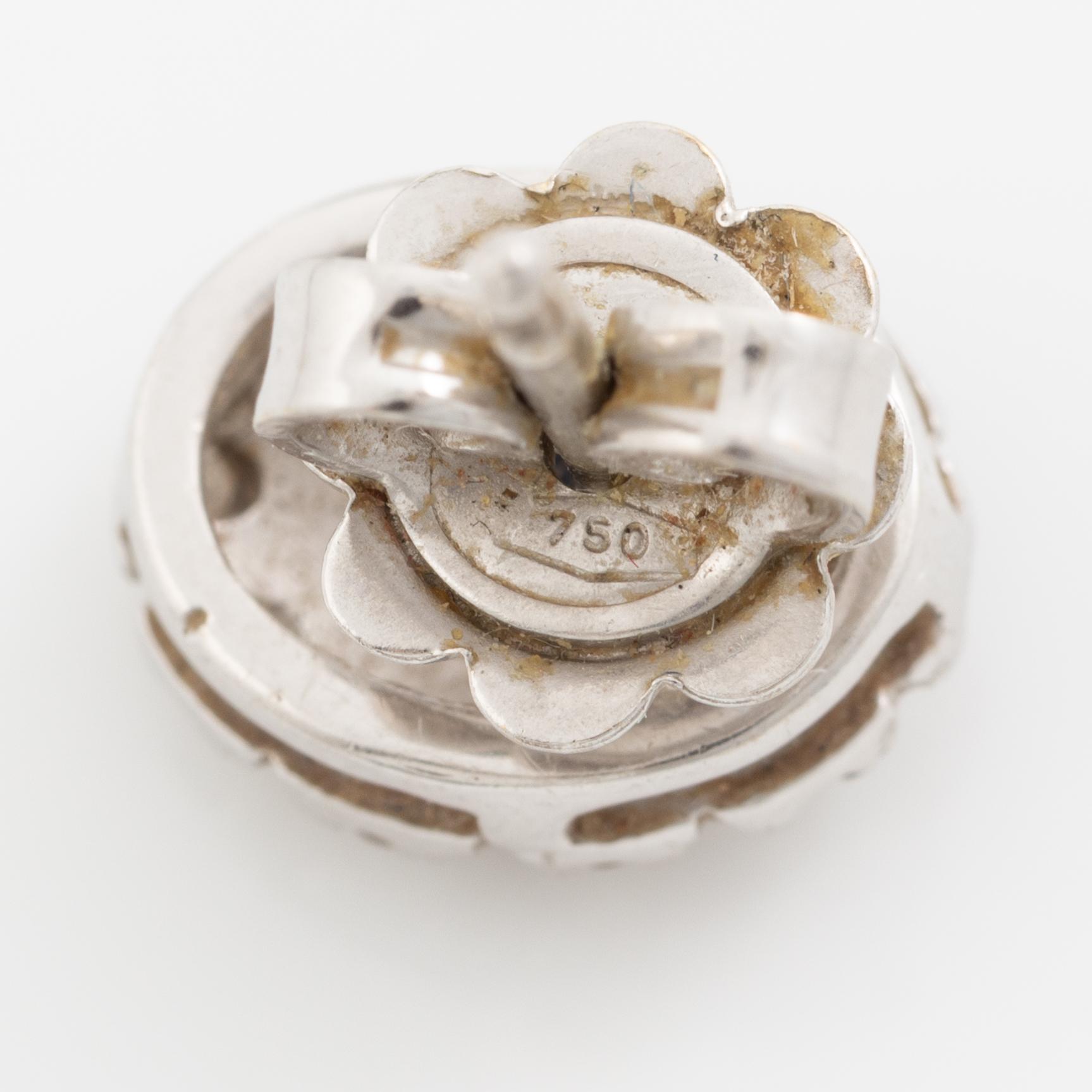 Earrings, a pair of 18K white gold set with dark sapphires and small brilliant-cut diamonds.