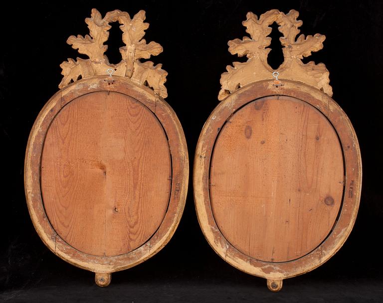 A pair of Gustavian two-light girandole mirrors by N. Meunier.