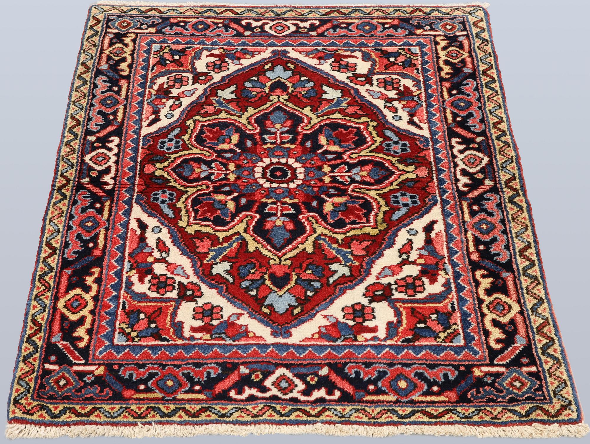 A Semi-antique Heriz rug, 90 x 78 cm.