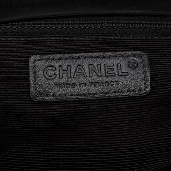 CHANEL, a black crochet flap evening shoulder bag.