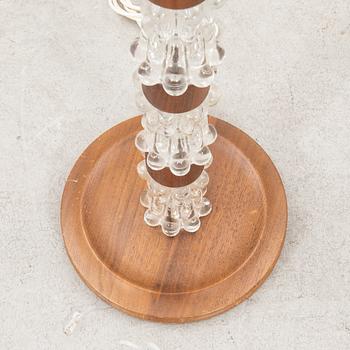 A 1970s wood and glass floor lamp.