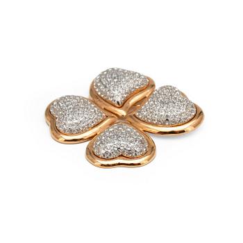 537. YVES SAINT LAURENT, a gold colored brooche with decorative stones.