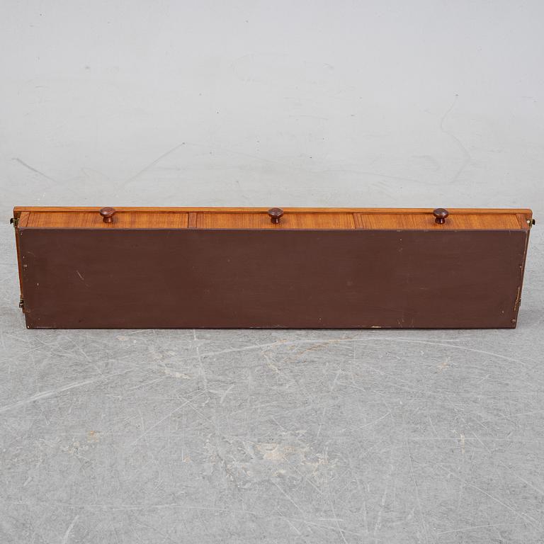 Nils Strinning, A 1950's-60's teak veneered shelf with brackets.