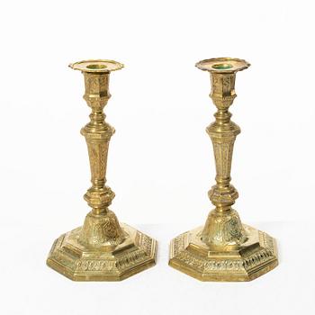 A pair of Louis XVI-style brass candle sticks, first half of the 20th century.