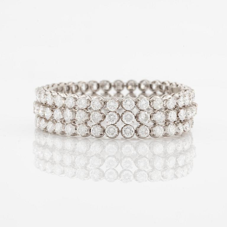 A platinum bracelet set with round brilliant-cut diamonds.