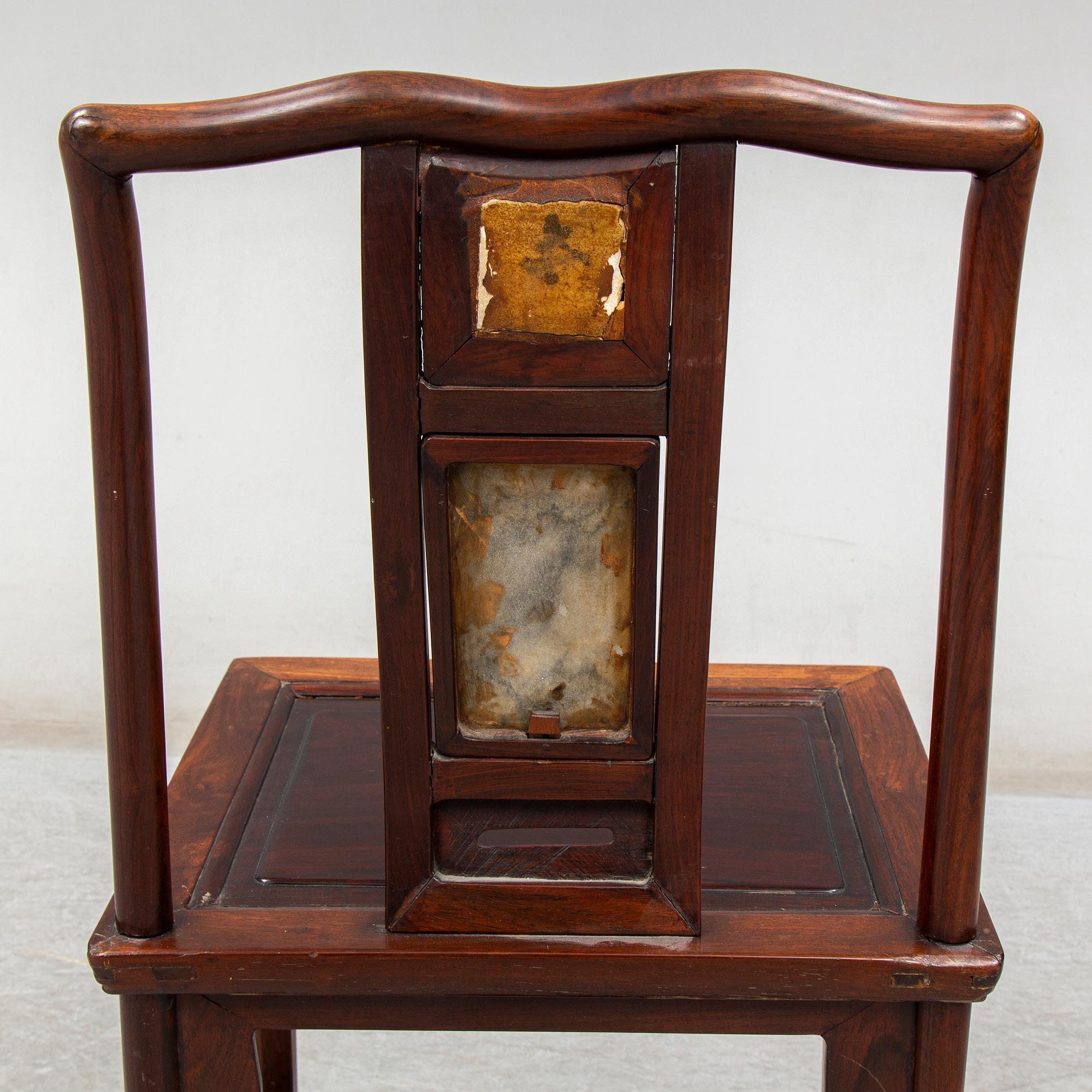 A pair of Chinese hardwood armchairs, early 20th century.