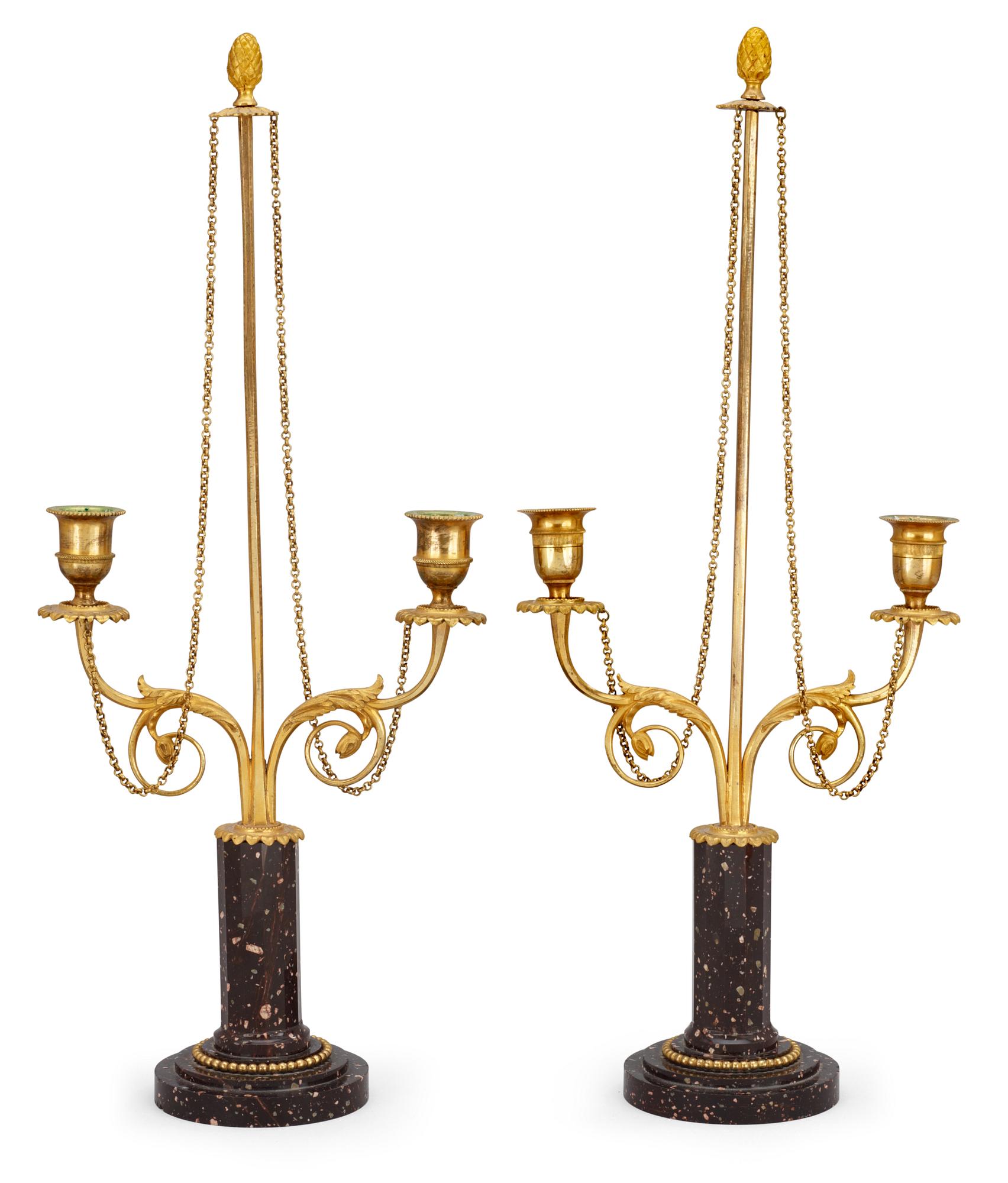 Two similar late Gustavian circa 1800 porphyry and gilt bronze two-light candlesticks.