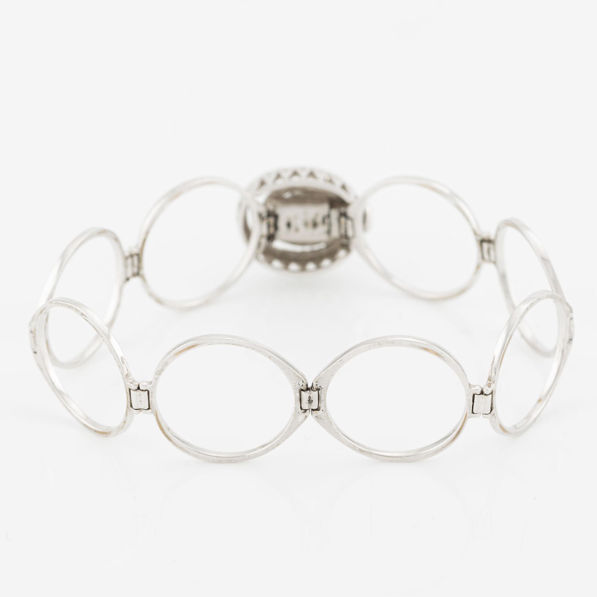Ring/armband 18K guld med runda briljantslipade diamanter.