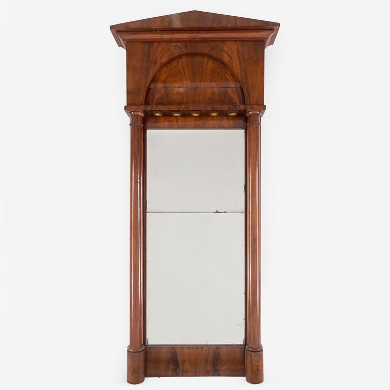 A first half of the 19th century mahogany veneered mirror.