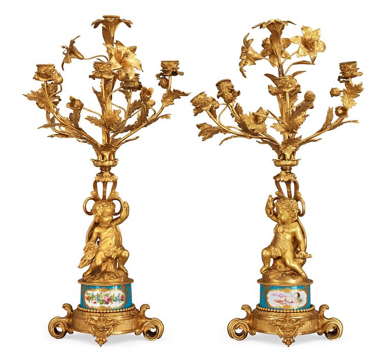 A pair of French 1860/70's gilt metal and porcelain six-light candelabra.